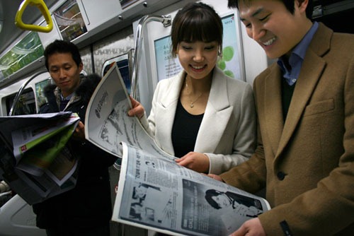 Today's newspaper (far left) vs the newsreader of the future (LG Display)